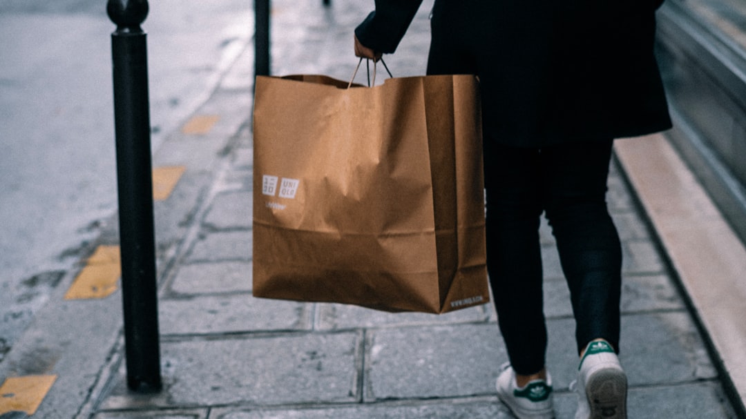 Services a-person-walking-down-a-sidewalk-with-a-brown-bag-rpfayhf6ys0