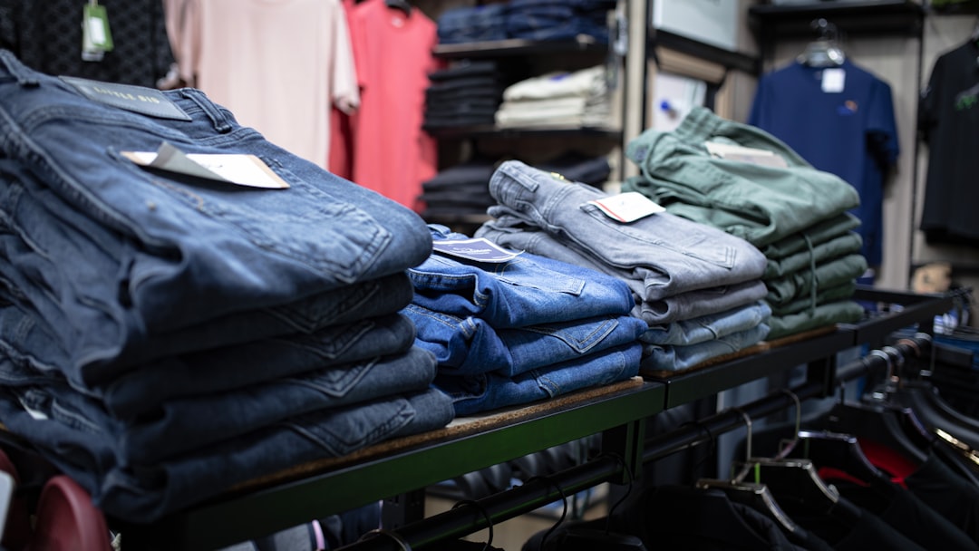 a-rack-of-folded-jeans-in-a-clothing-store-pqogu-ntwty